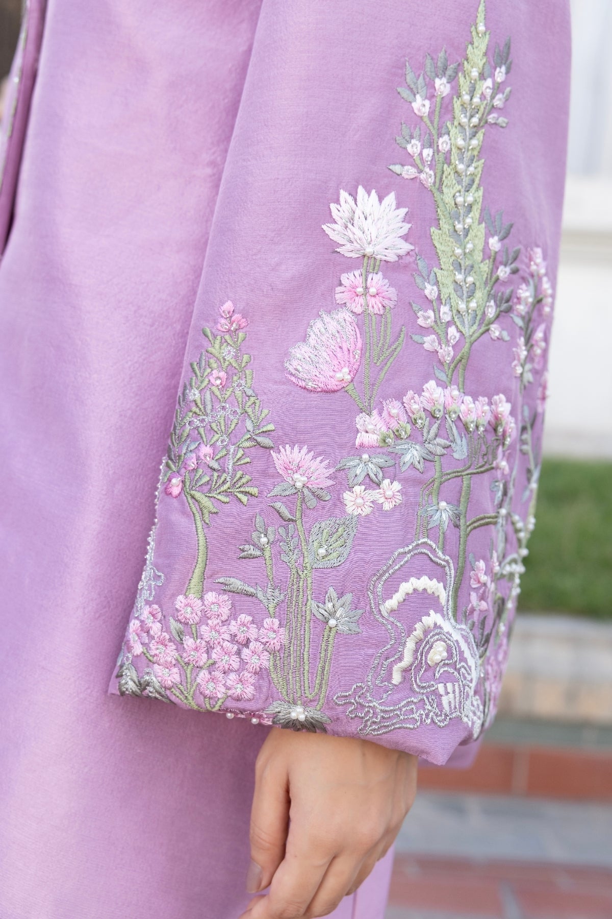 Huma Mistry Official Wisteria floral artwork featuring delicate purple and green botanical details on textured paper